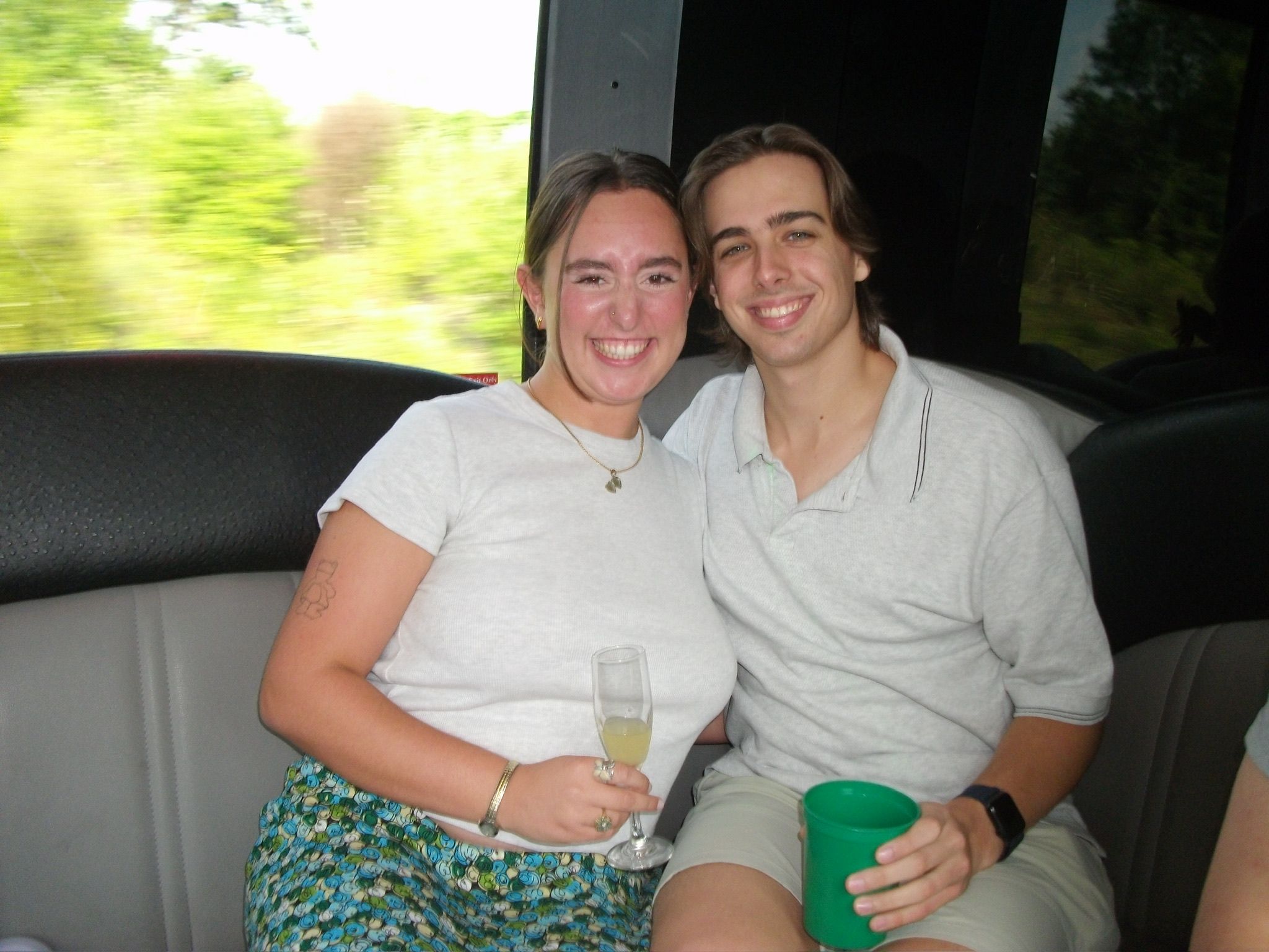 Andrew and Grace sitting close together with drinks in hand