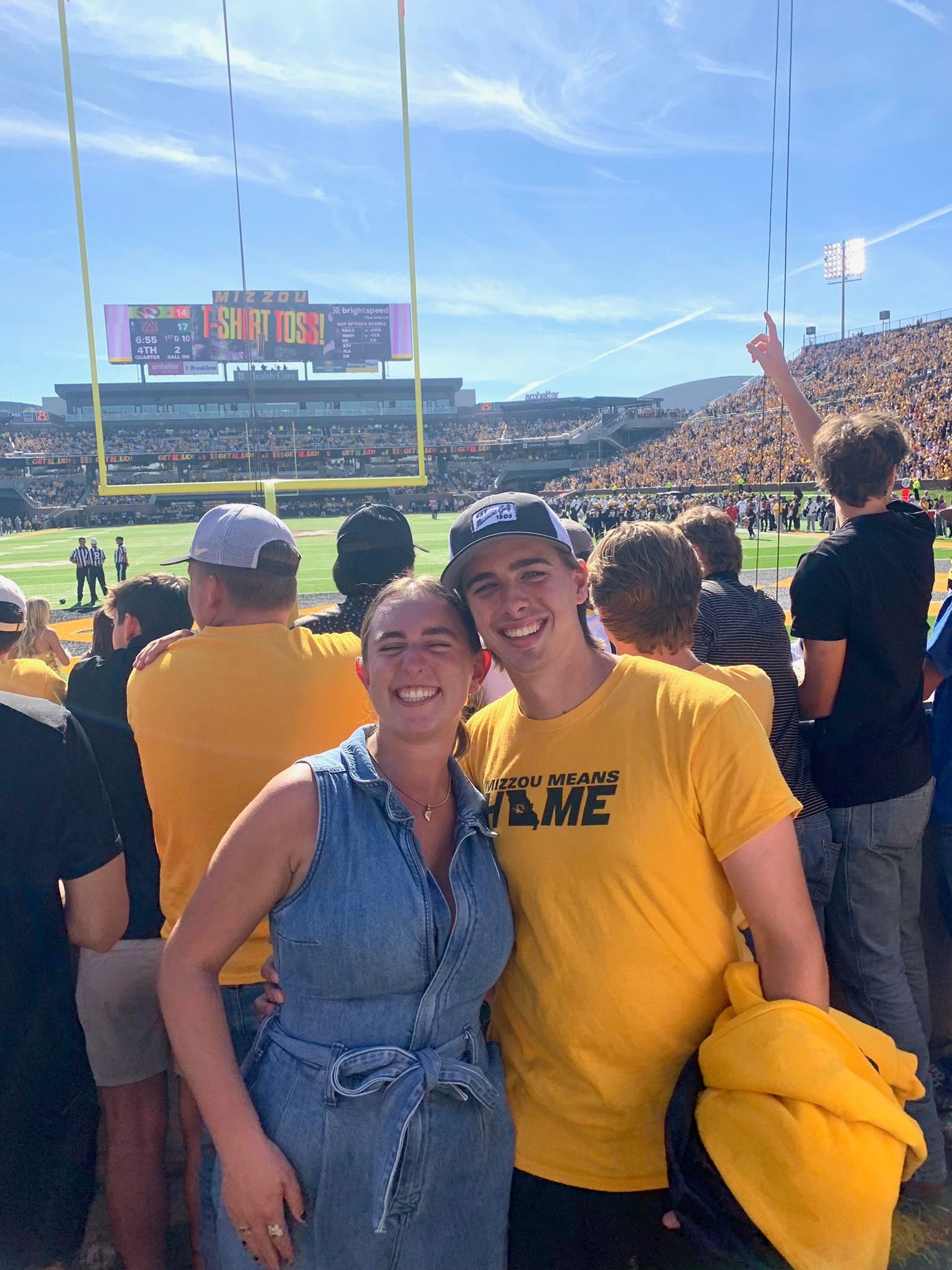 Andrew and Grace in the stands at a football game