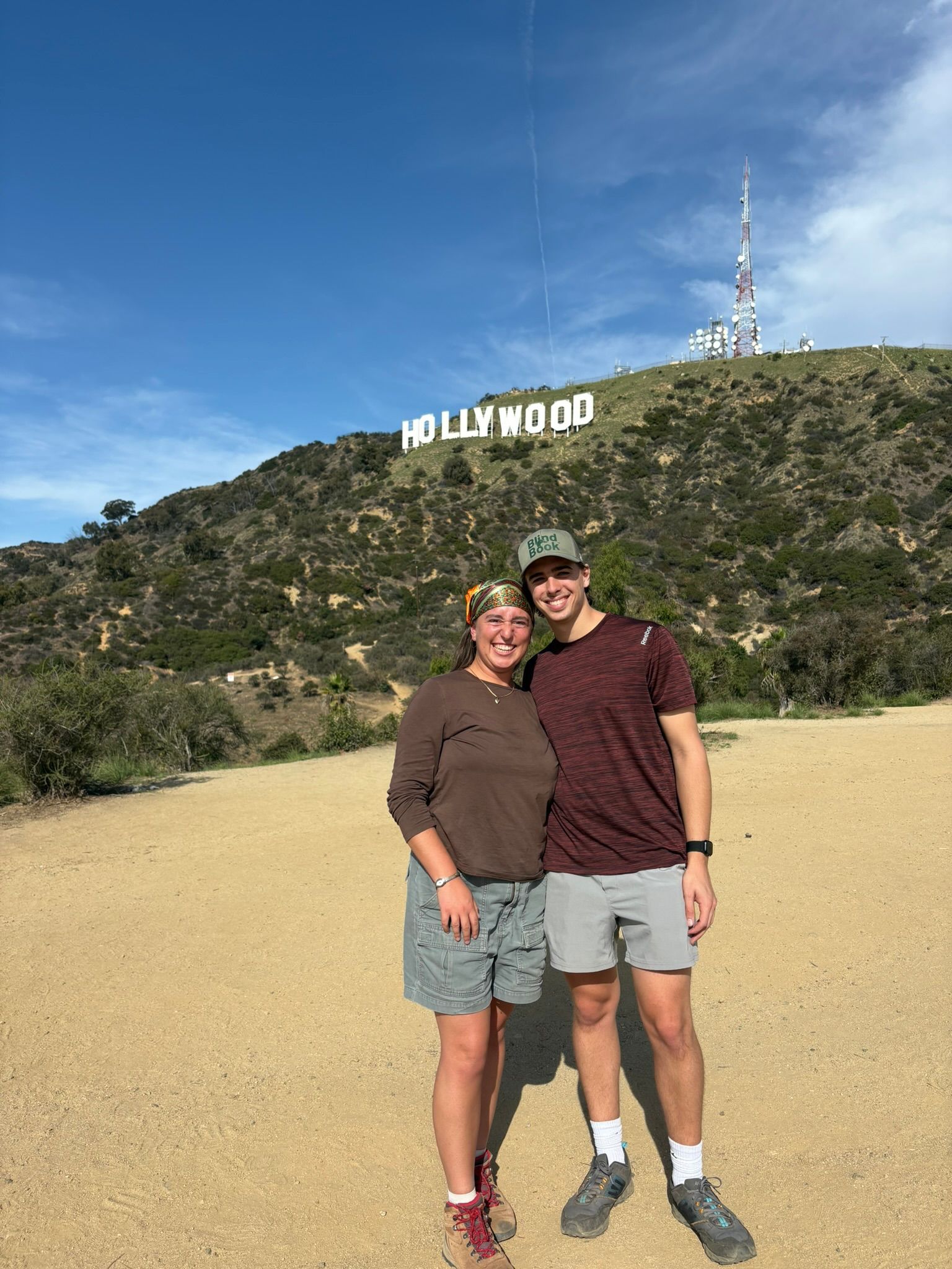 Andrew and Grace on a hilltop below the Hollywood sign