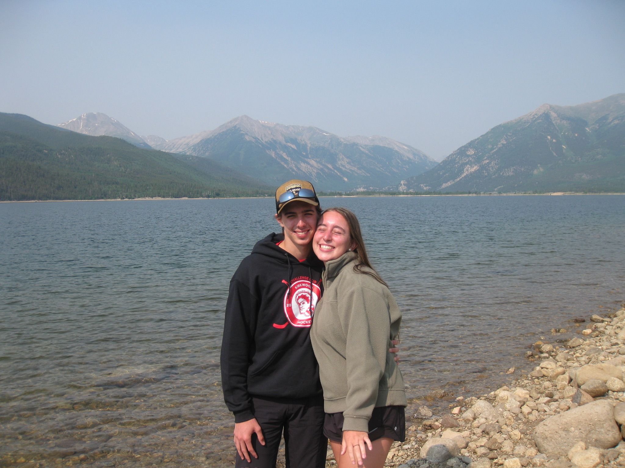 Andrew and Grace on the shore of a mountain lake