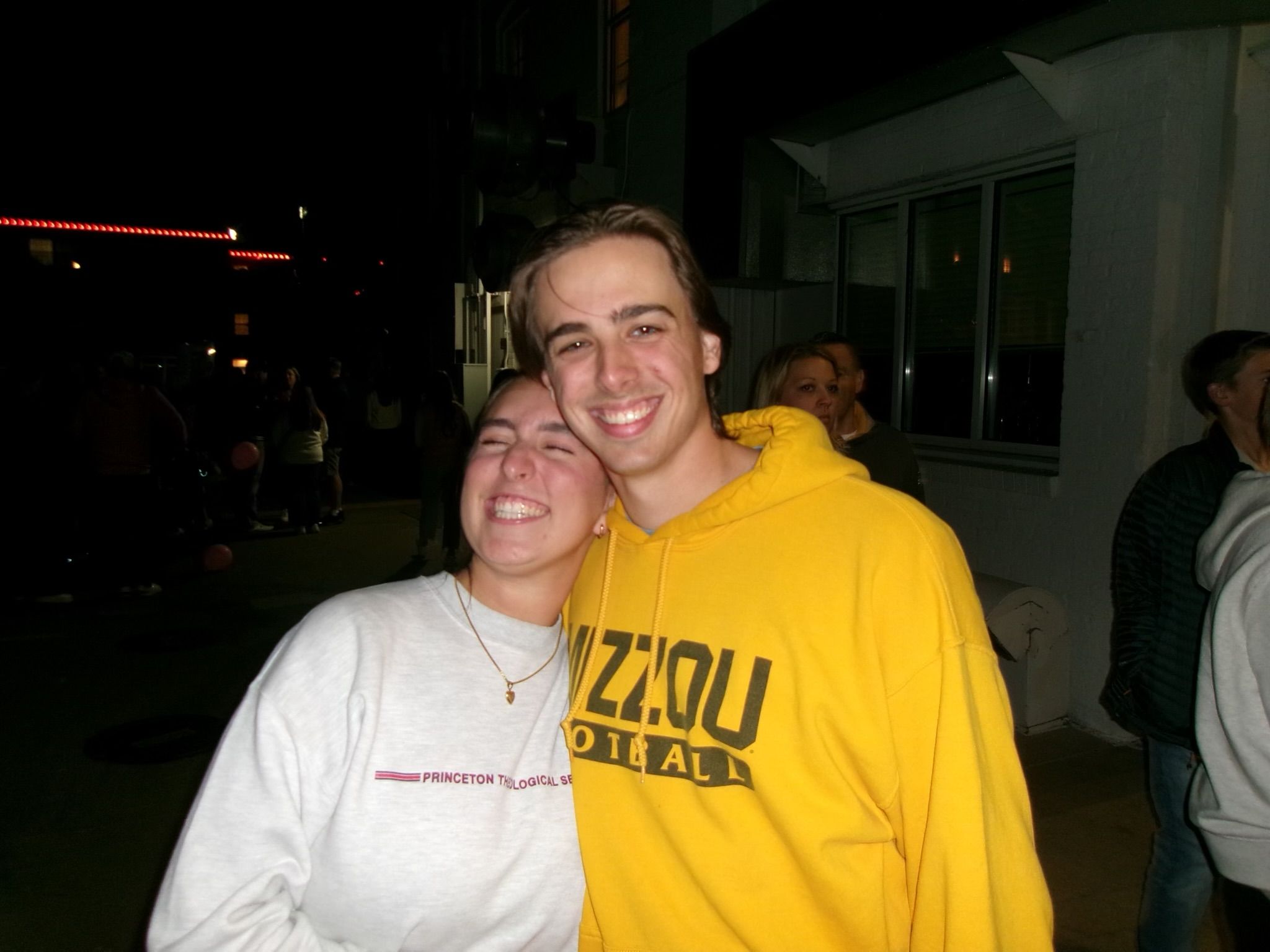 Andrew and Grace at night, Andrew in a yellow Mizzou sweatshirt