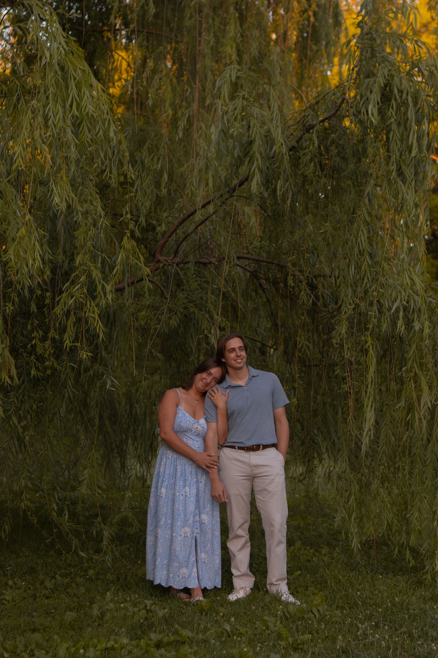 Andrew and Grace standing in front of a weeping willow